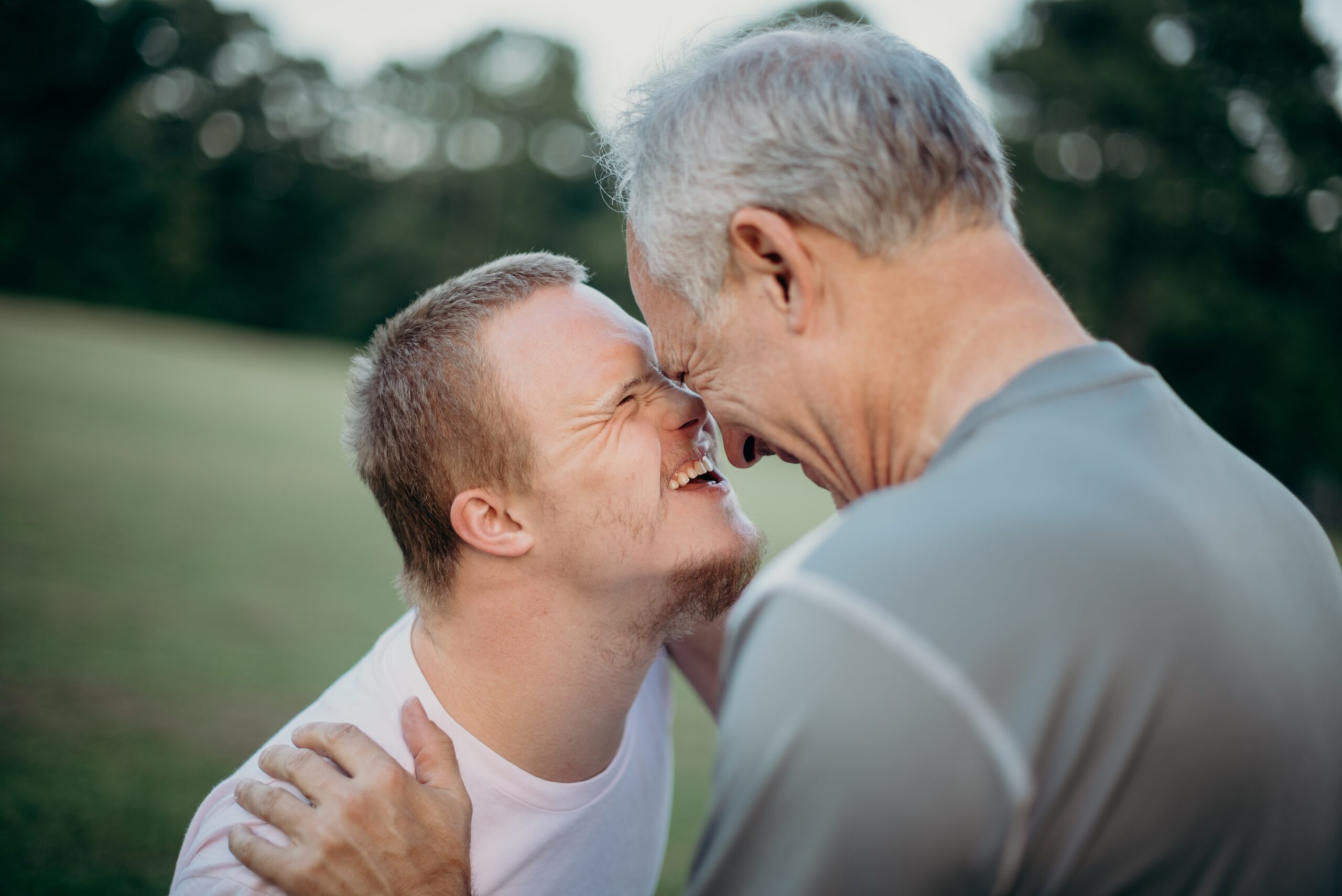 Image of two people laughing together - how to support persons with disabilities image