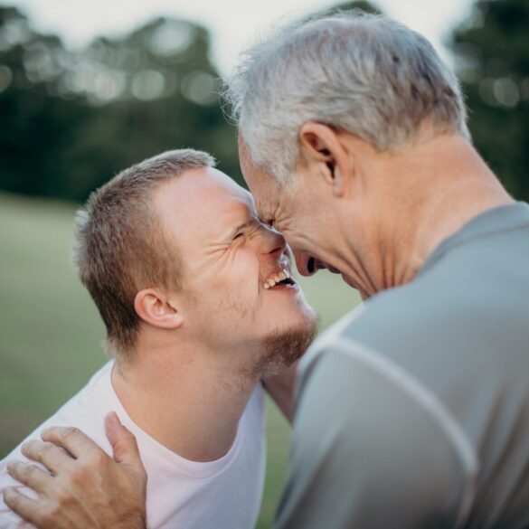 Image of two people laughing together - how to support persons with disabilities image