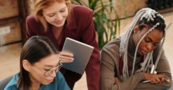 A group of students are gathered at a desk