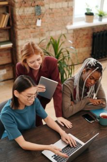 A group of students are gathered at a desk