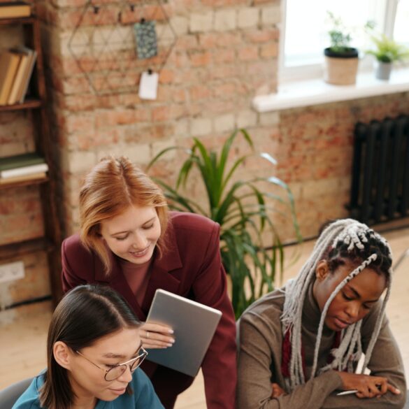A group of students are gathered at a desk
